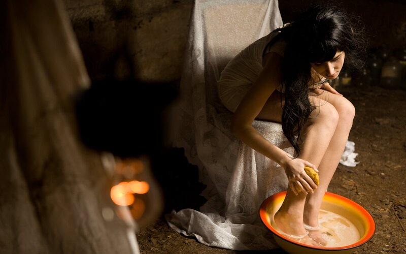 woman washing feet in basin