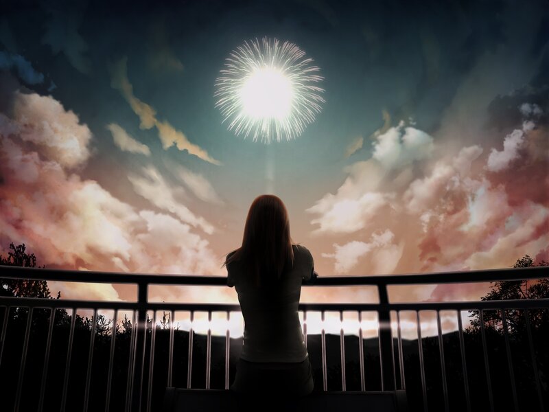 Woman watching fireworks at night