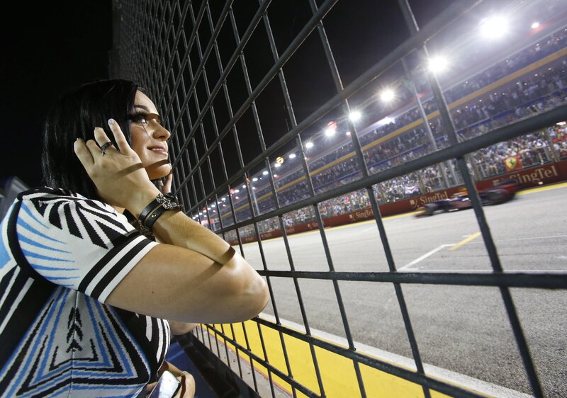 Woman watching race at night