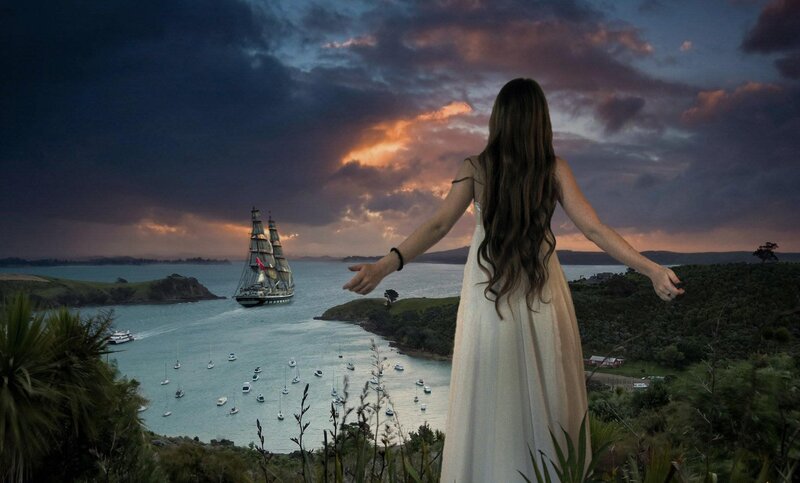 Woman watching ship at sunset