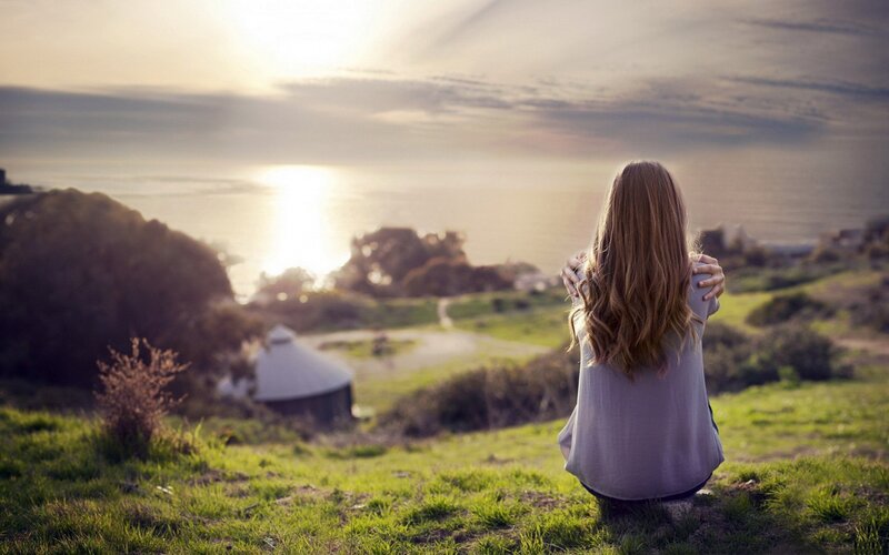 woman watching sunset by the sea