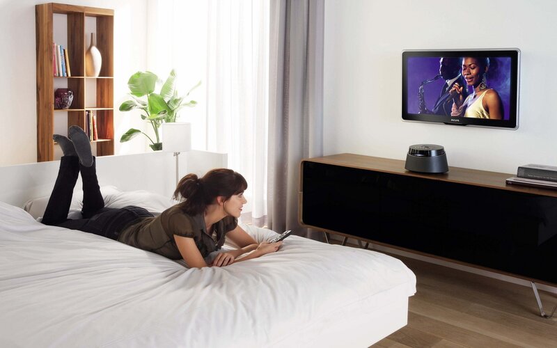 Woman watching TV in bedroom