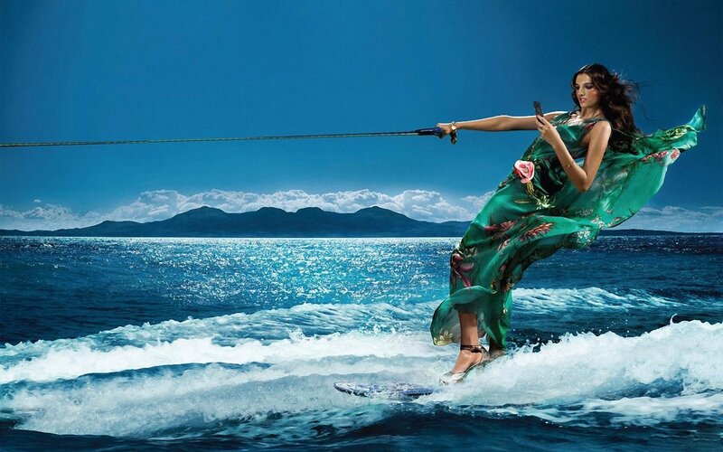 Woman water skiing in green dress