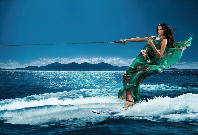 woman water skiing in green dress
