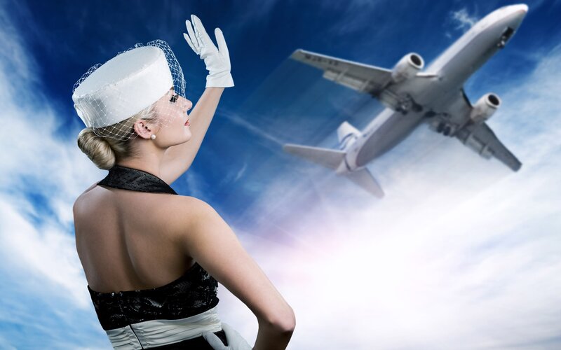 woman waving at airplane
