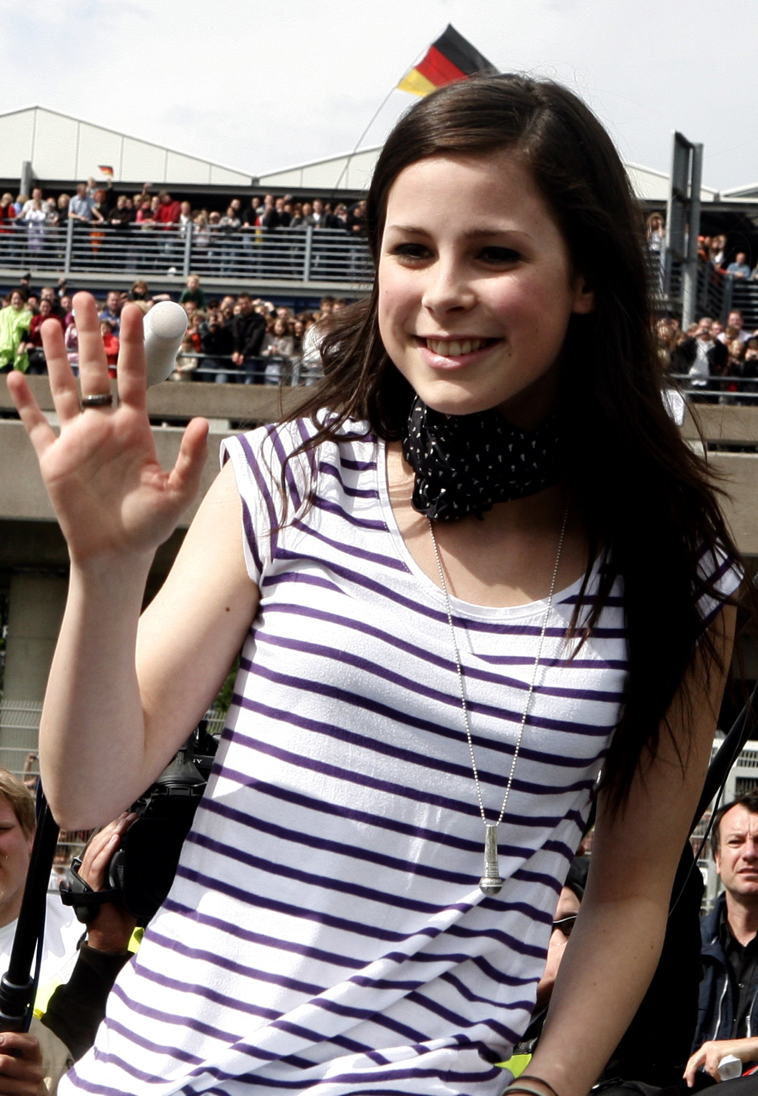 woman waving at crowd