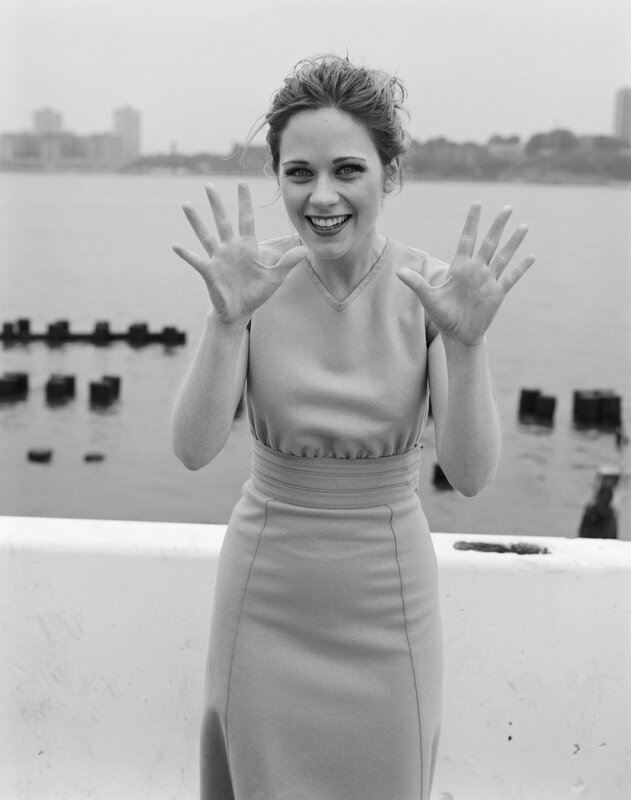 woman waving by the water