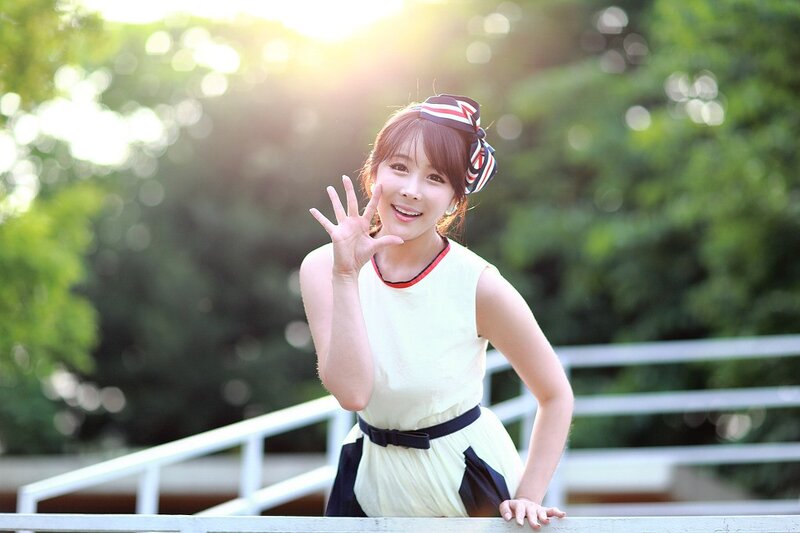 woman waving in sunlight
