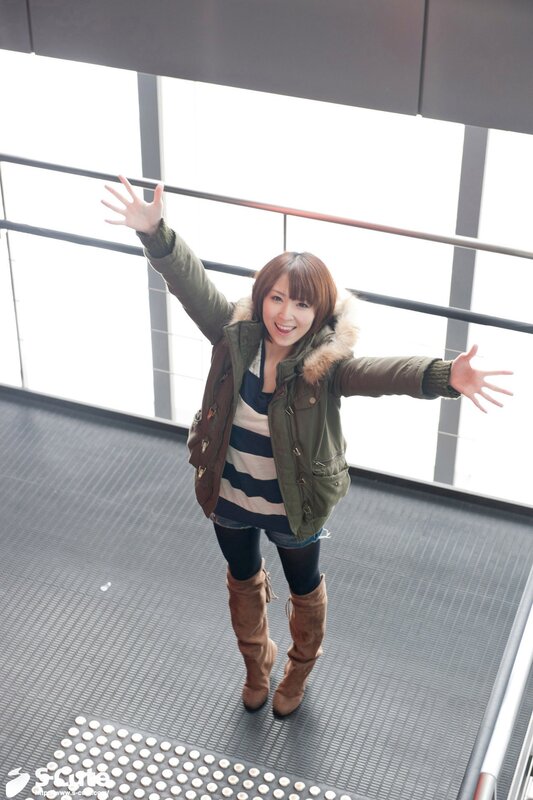Woman waving in winter coat