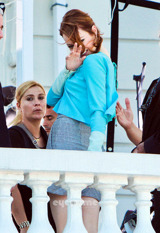 woman waving on balcony