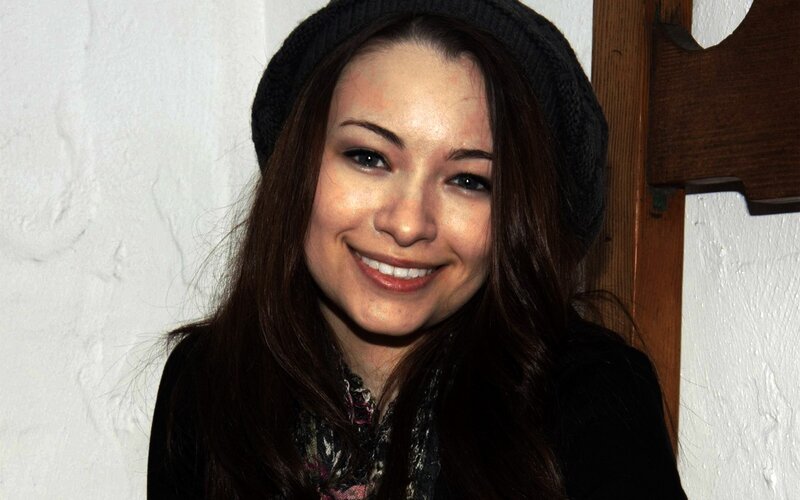 woman wearing a beanie smiling