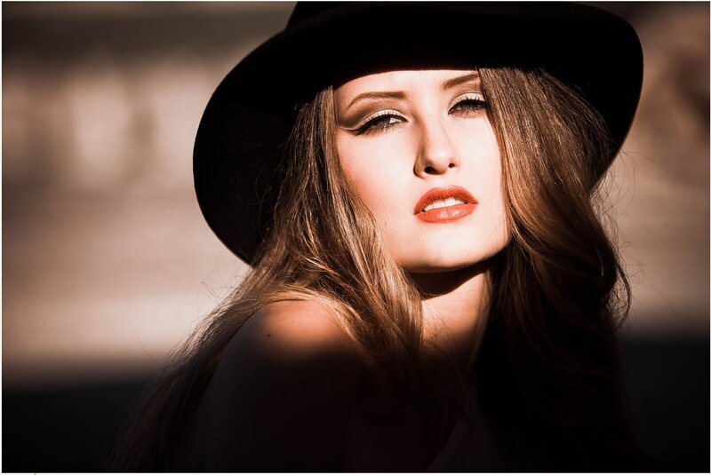 Woman Wearing Black Hat — Brown, Dramatic