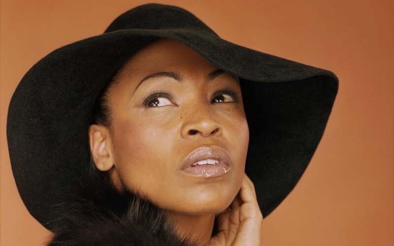 Woman Wearing Black Hat — Contemplative, Photograph