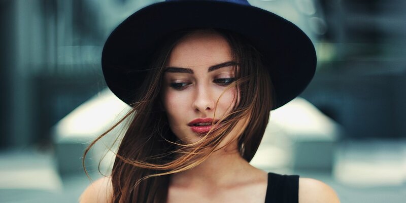 Woman Wearing Black Hat — Contemplative