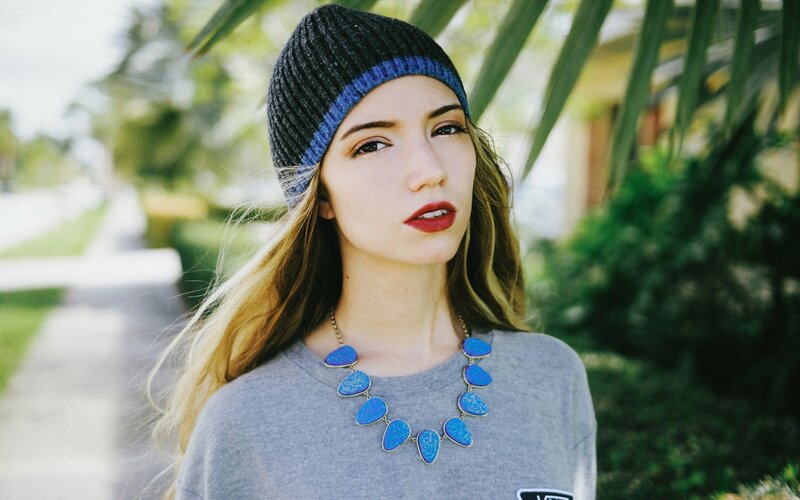 woman wearing blue necklace