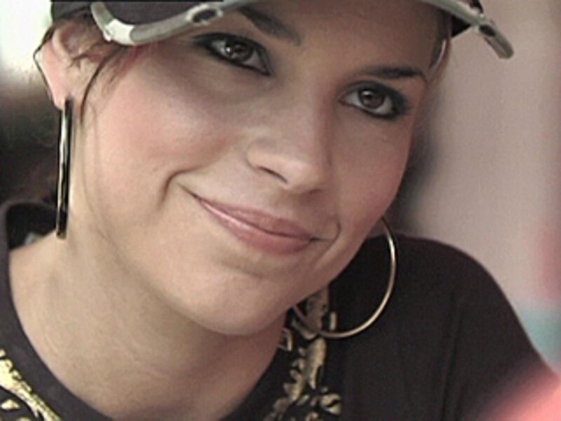 woman wearing cap and hoop earrings