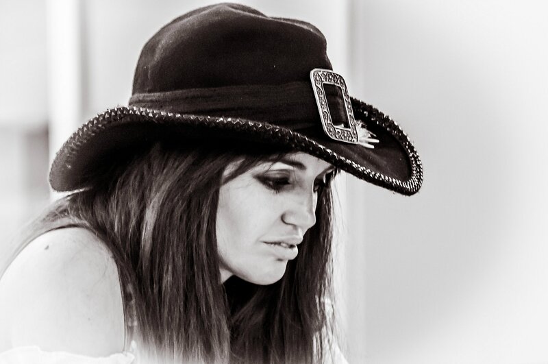 Woman Wearing Cowboy Hat — Black, Contemplative, Photograph