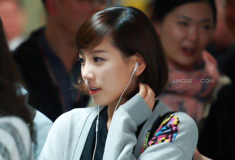 woman wearing earphones in crowd
