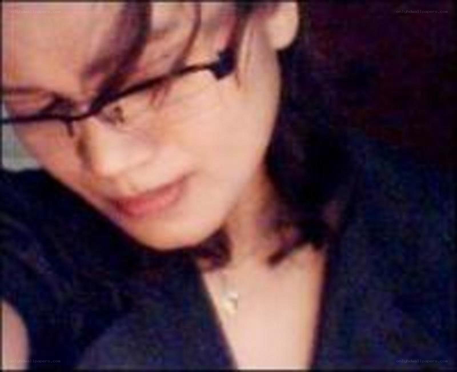 woman wearing glasses looking down