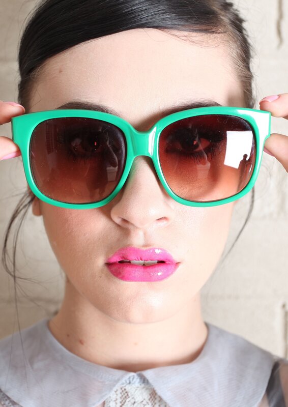 woman wearing green sunglasses
