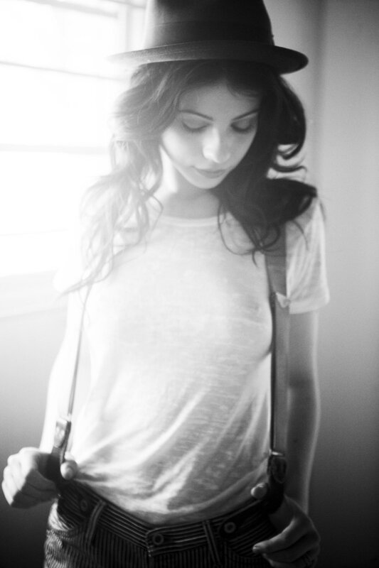 Woman Wearing Hat and Suspenders