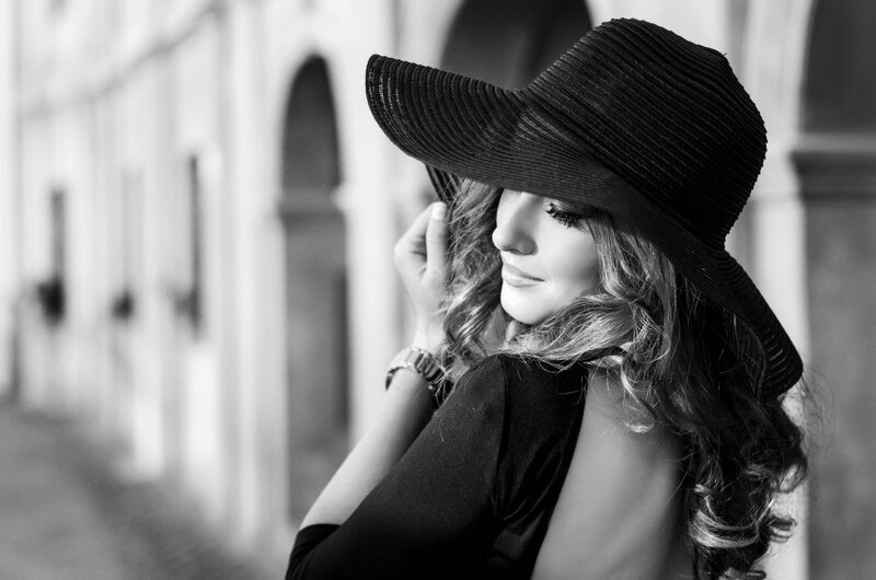 Woman Wearing Hat — Black, Dramatic, Photograph, Building
