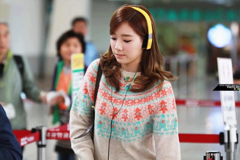 woman wearing headphones at airport
