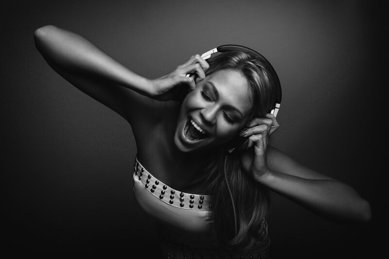 Woman Wearing Headphones — Black, Dramatic, Photograph, Studded Top