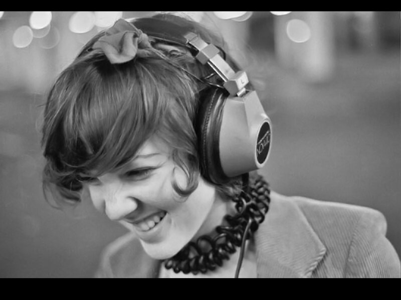 woman wearing headphones smiling