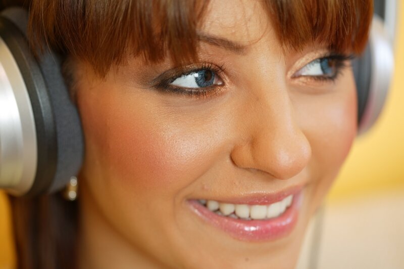 woman wearing headphones smiling