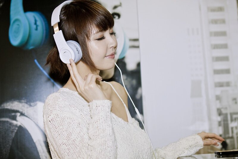Woman Wearing Headphones — White, Calm, Photograph, Sweater