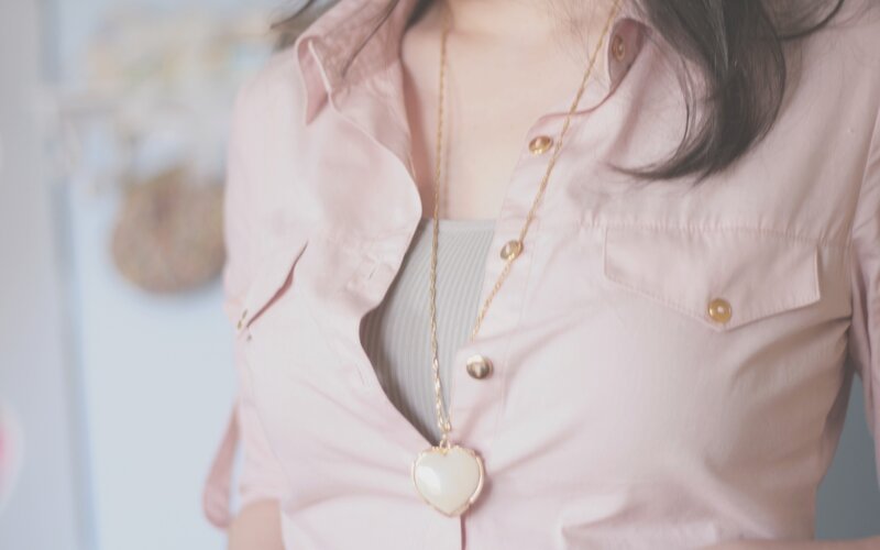 woman wearing heart necklace