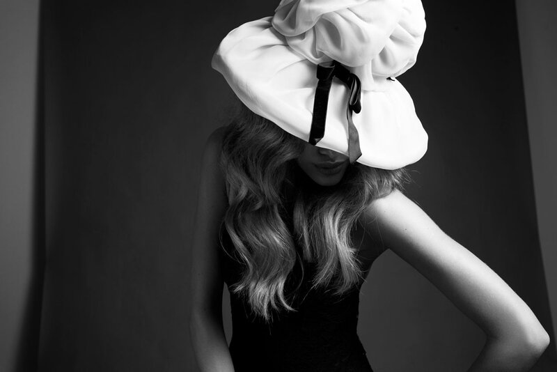 Woman Wearing Large Hat — Black, Dramatic, Photograph