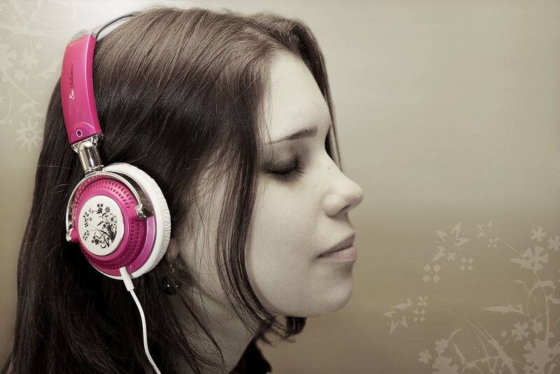 woman wearing pink headphones