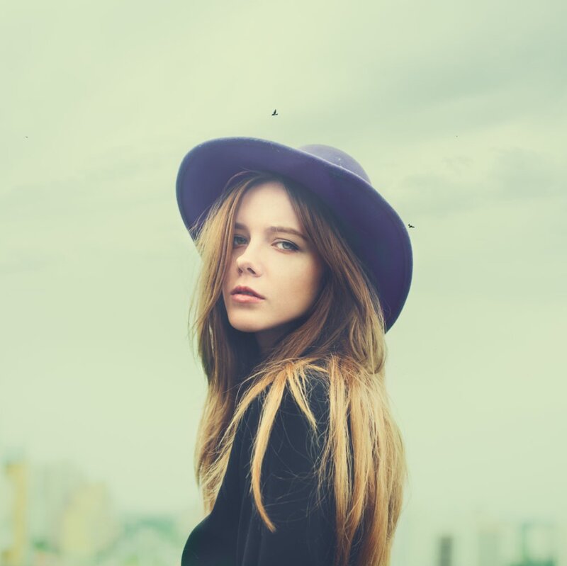 Woman Wearing Purple Hat — Contemplative