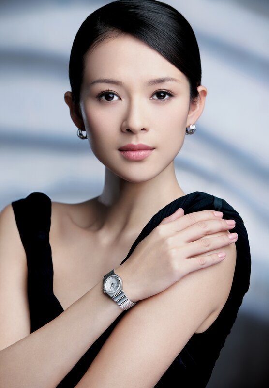 woman wearing watch and earrings