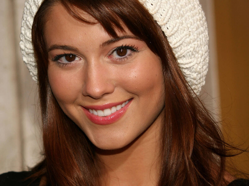 woman wearing white hat smiling