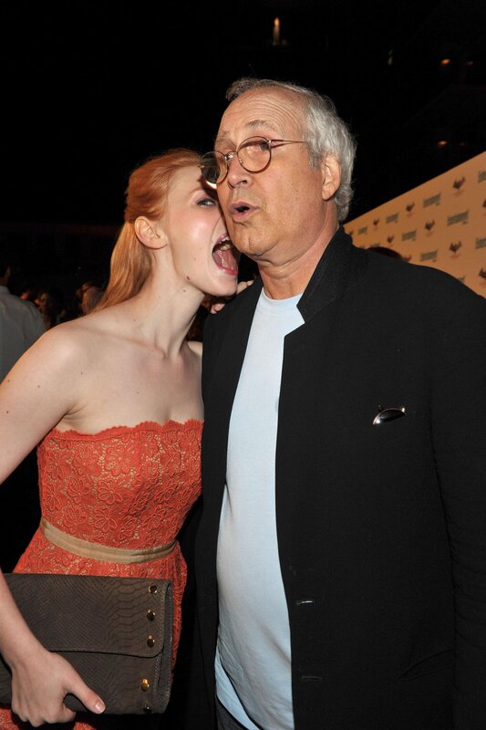 woman whispering to man at event