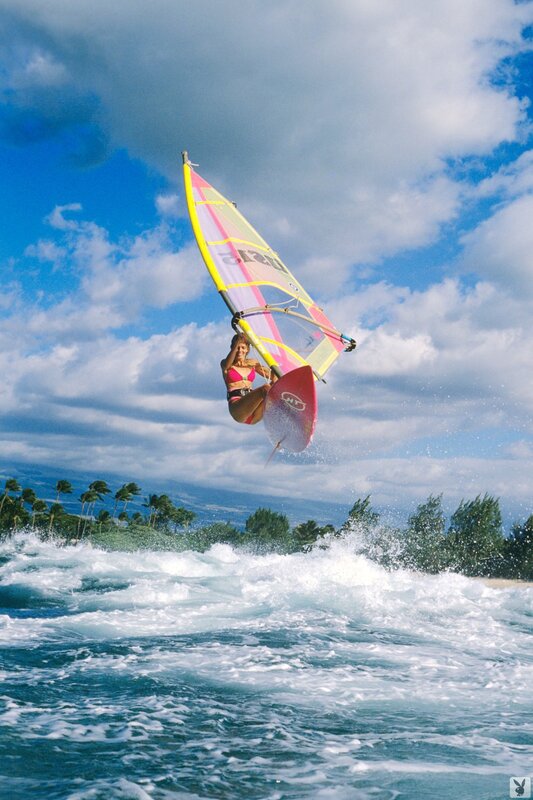 woman windsurfing in mid-air