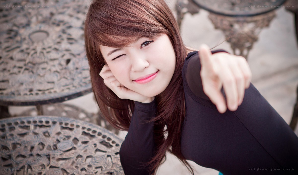 woman winking and pointing