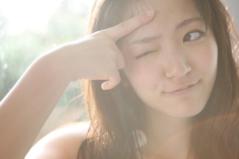 Woman Winking at Camera — Brown, Playful