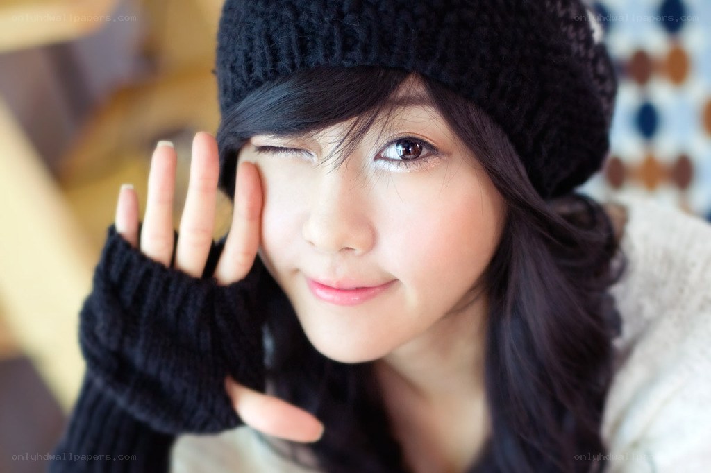 woman winking in winter hat