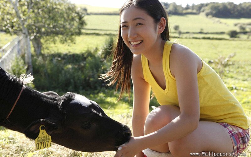 Woman with a calf in a field