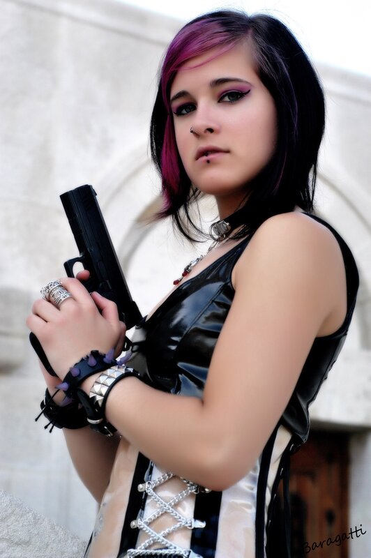 Woman with a gun in goth attire