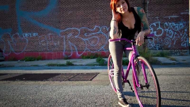 Woman with a pink bicycle