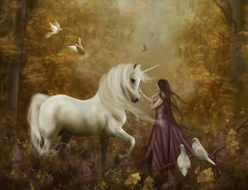 Woman with a unicorn in the forest