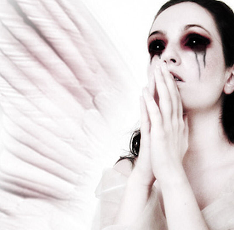 woman with angel wings and dark makeup