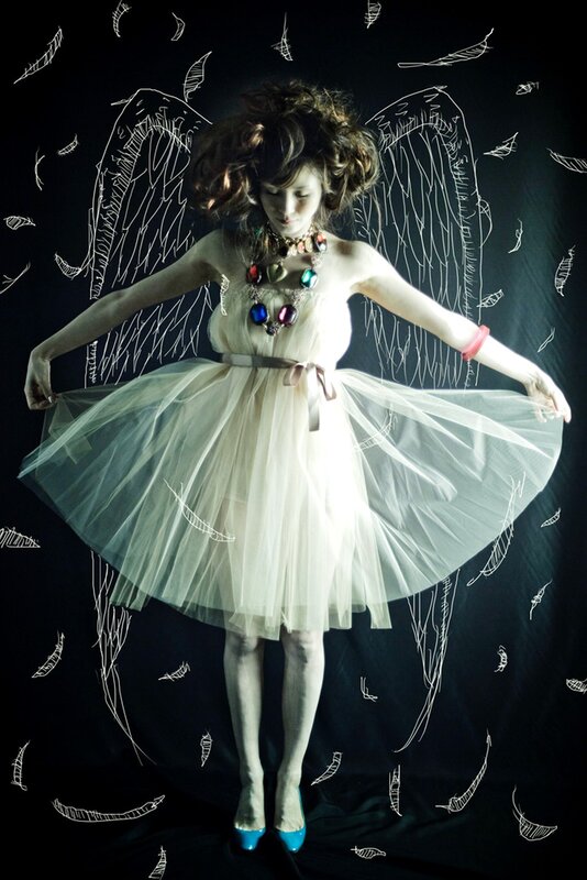 woman with angel wings and tulle dress