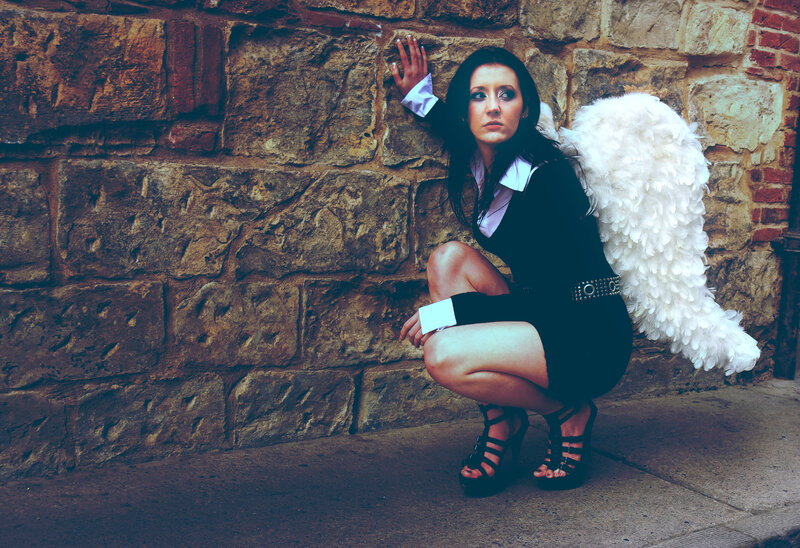 woman with angel wings crouching