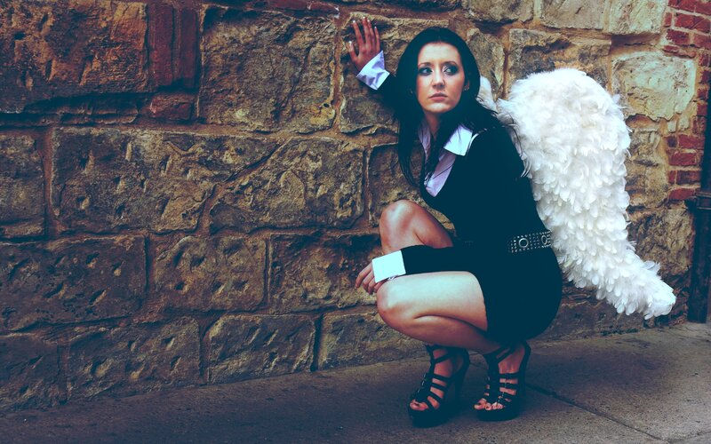 woman with angel wings crouching